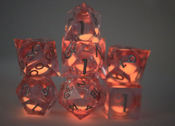 Sharp Edge Glow in the Dark Liquid Core RPG Dice Set - Radiant Pink Plastic Dice Foam Brain Games